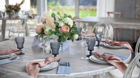 Catering table set service with silverware, napkin and glass at restaurant Stock Photos