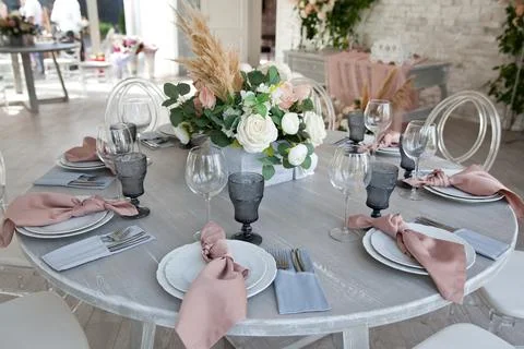 Catering table set service with silverware, napkin and glass at restaurant be Stock Photos