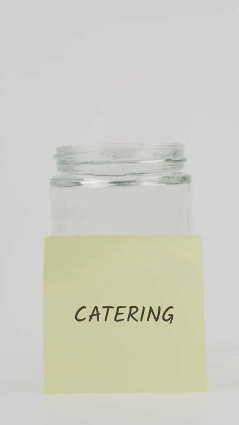 Catering text or word on yellow sticky note attached to glass jar with hand Stock Footage 311690000