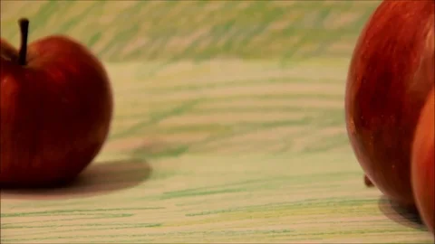 Caterpillar crawling past red apples Stock Footage 77862409