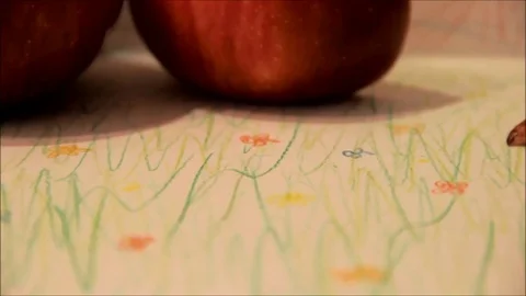 Caterpillar crawling past red apples Stock Footage 77862981