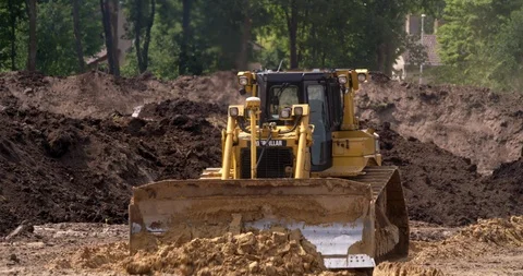 Caterpillar earth mover in action at construction site, Netherlands 4K Stock Footage 109571735