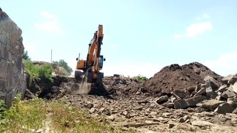 Caterpillar excavator moves the soil on the construction site, earthworks Stock Footage 217544784