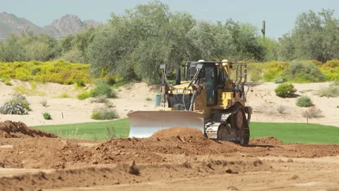 Caterpillar scraper, land mover, grades the dirt Stock Footage 214283838