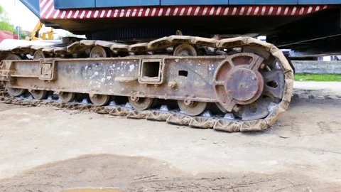 Caterpillar tractor or crane standing on the ground, not moving, dirty, rusty. D Stock Footage 81917189