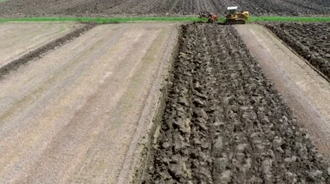 A caterpillar tractor plowing the ground 07 - aerial shot Stock Footage 40281078