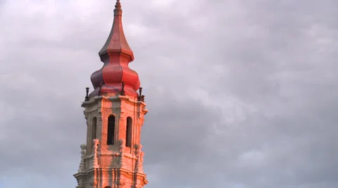 Cathedral belfry tower in sunset light against moving clouds Stock Footage 38716072