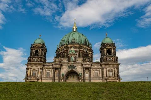 The cathedral of Berlin with a meadow in front Stock Photos