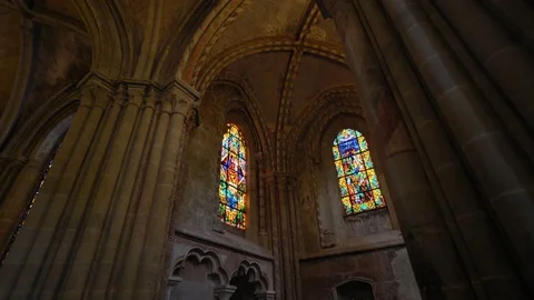 Cathedral Interior - discovering beautiful stained glass through the arch Stock Footage 79923342