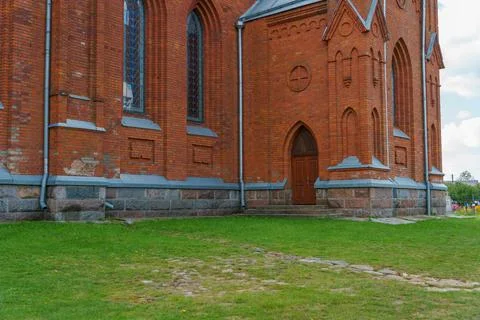 The Catholic church. The old red brick church. A historical building with a r Stock Photos