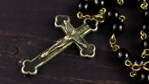 Catholic rosary on a dark wooden background Stock Footage