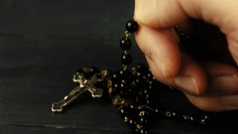Catholic rosary in the hands of a person praying Stock Footage