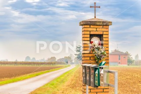 Catholic votive edicola next to mailboxes Stock Photos