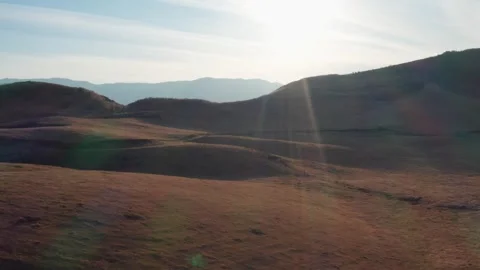 Cattle ranch at sunset brown winter grass Mt Aso Stock-Footage 260851343