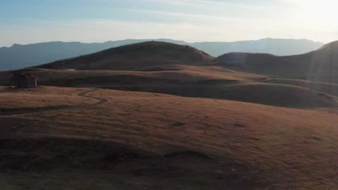 Cattle ranch at sunset brown winter grass Mt Aso Stock Footage 260851656