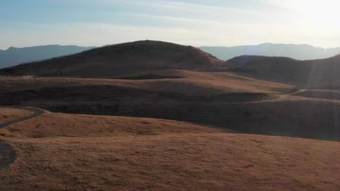 Cattle ranch at sunset brown winter grass Mt Aso Stock Footage 260851847