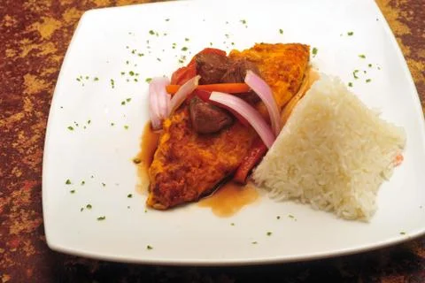 Cau cau,peruvian food,fried,onion tomato bean frijol tripe  with rice Stock Photos