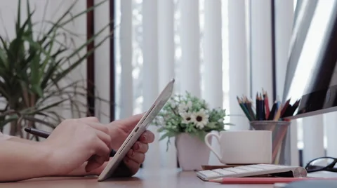 Caucasian adult female uses  tablet on her desk Stock Footage 59741913