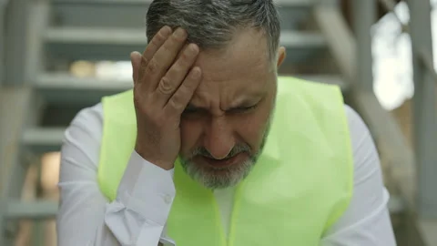 Caucasian aged engineer suffering from migraine outdoors Stock Footage 197080331