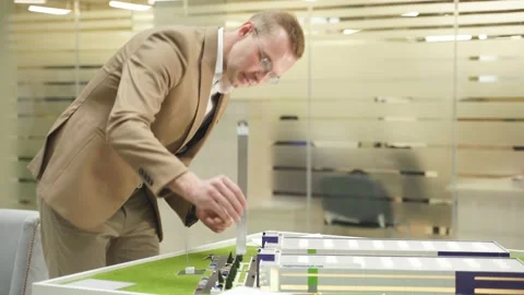 Caucasian architect engineer man is concentrated on designing building and ther Stock Footage 145357307