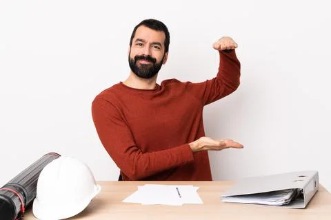 Caucasian architect man with beard in a table holding copyspace to insert an  Stock Photos