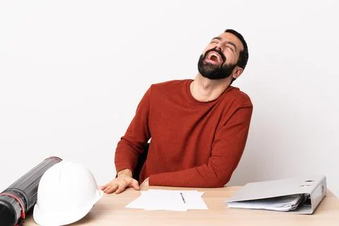 Caucasian architect man with beard in a table laughing Stock Photos