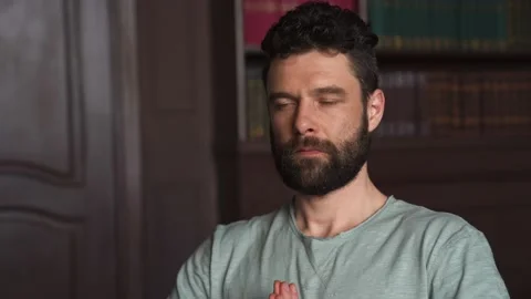 Caucasian Attractive Man Sitting Basic Yoga Pose, Deep Breathing and Meditating Stock Footage 152568593
