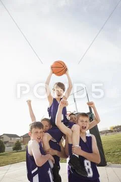Caucasian basketball team cheering on court Stock Photos