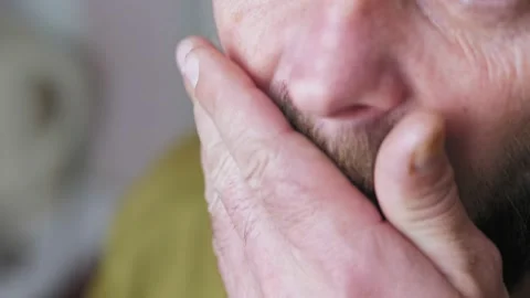 Caucasian bearded man drinking coffee in the kitchen. Close-up of a man with a 스톡 동영상 227558739