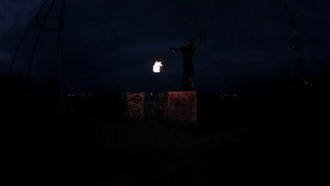 Caucasian bearded man performing with fire rope dart on night city glare light 스톡 동영상 114157287