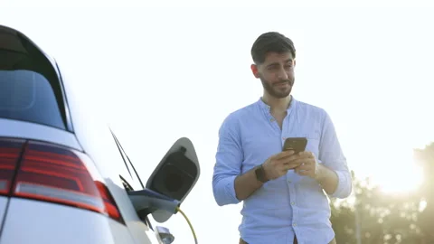 Caucasian bearded man using smart phone and waiting power supply connect to Stock Footage 200954428