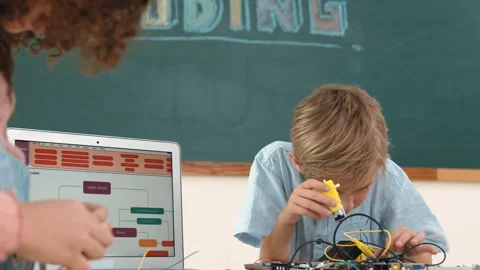 Caucasian boy fixing main board by using screwdriver at stem lesson. Pedagogy. Stock Footage 273669774