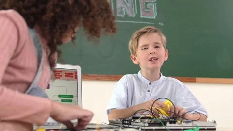 Caucasian boy fixing main board while looking at camera in stem class. Pedagogy. Stock Footage 274743289