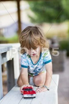 Caucasian Boy Playing With Toy Car