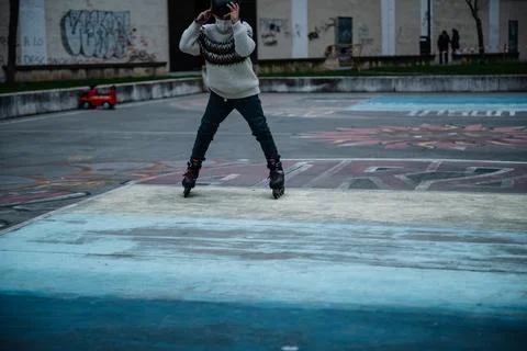 Caucasian boy practises roller skating in a city park Stock Photos