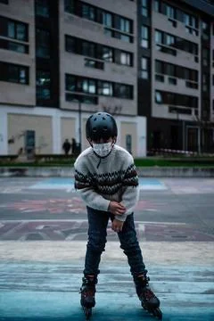 Caucasian boy practises roller skating in a city park Stock Photos