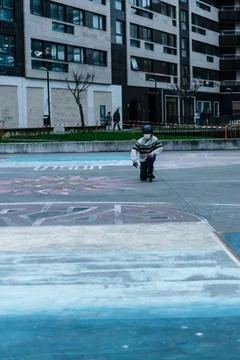 Caucasian boy practises roller skating in a city park Stock Photos