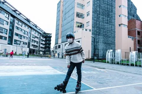 Caucasian boy practises roller skating in a city park Stock Photos
