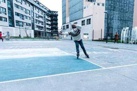 Caucasian boy practises roller skating in a city park Stock Photos