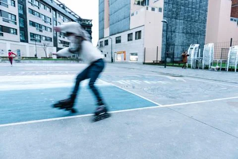 Caucasian boy practises roller skating in a city park Stock Photos