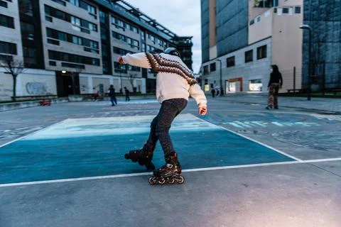 Caucasian boy practises roller skating in a city park Stock Photos