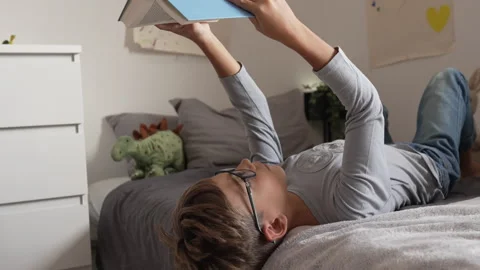 Caucasian boy pupil student read book at home study learn slow motion Stock-Footage 249809034