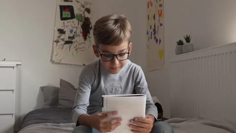 Caucasian boy pupil student read book at home study learn slow motion Stock-Footage 249809077