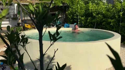 Caucasian boy relaxes in the pool Stock Footage 146875309