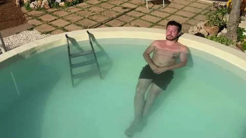 Caucasian boy relaxes in the pool Stock Footage 146879188