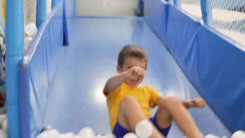 Caucasian boy sliding in playground. Stock Footage 264082209
