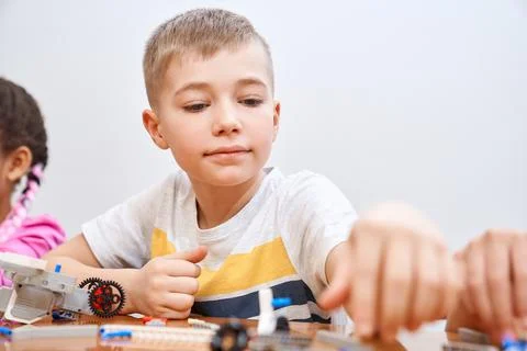Caucasian boy using building kit. Stock Photos