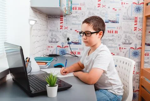 Caucasian boy using desktop computer for online study homeschooling Foto stock