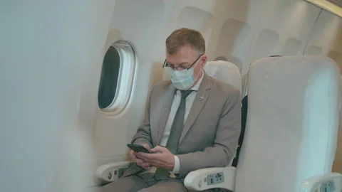A Caucasian business man is using smart phone in aircraft Stock Footage 150652090