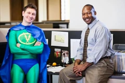 A caucasian businessman office super hero and his black business man partner. Stock Photos